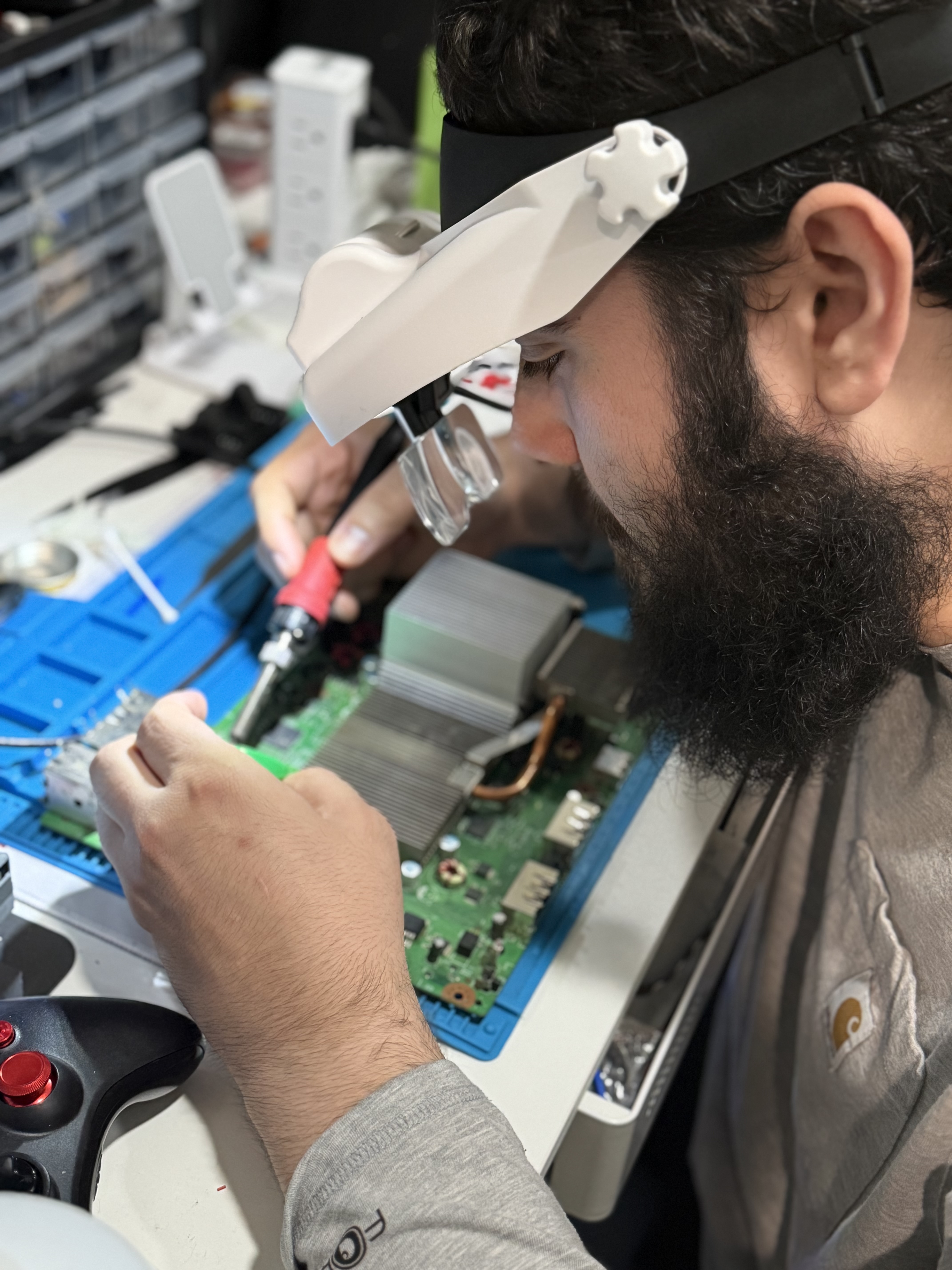 Josh, co-owner of Brothers in Arms Electronic Repair, soldering a circuit board